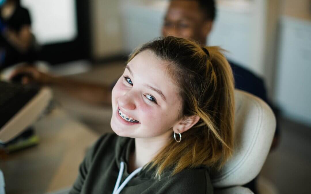 girl with braces smiles